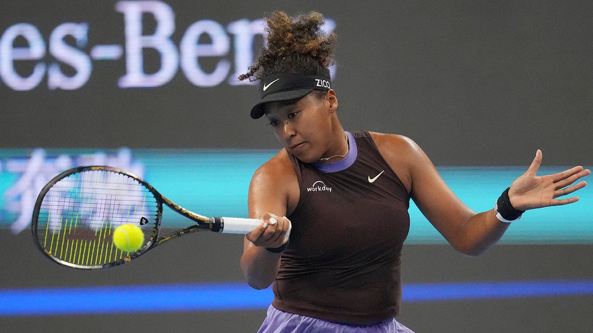 Naomi Osaka returns a shot