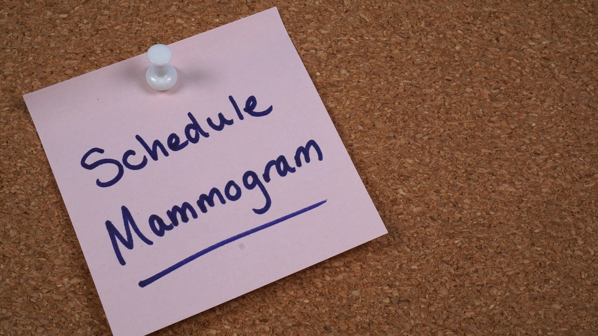 A note on a board with a reminder to schedule a mammogram