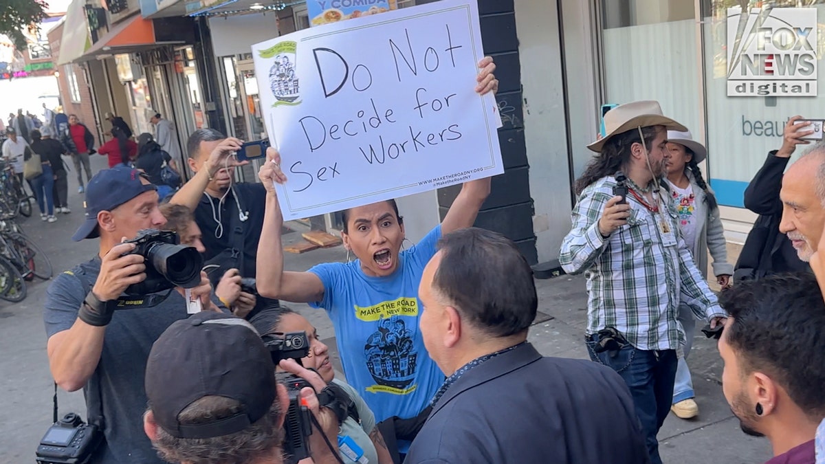 Protester heckles Hiram Monserrate following a rally in Queens