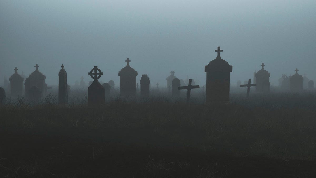 Spooky graveyard at night