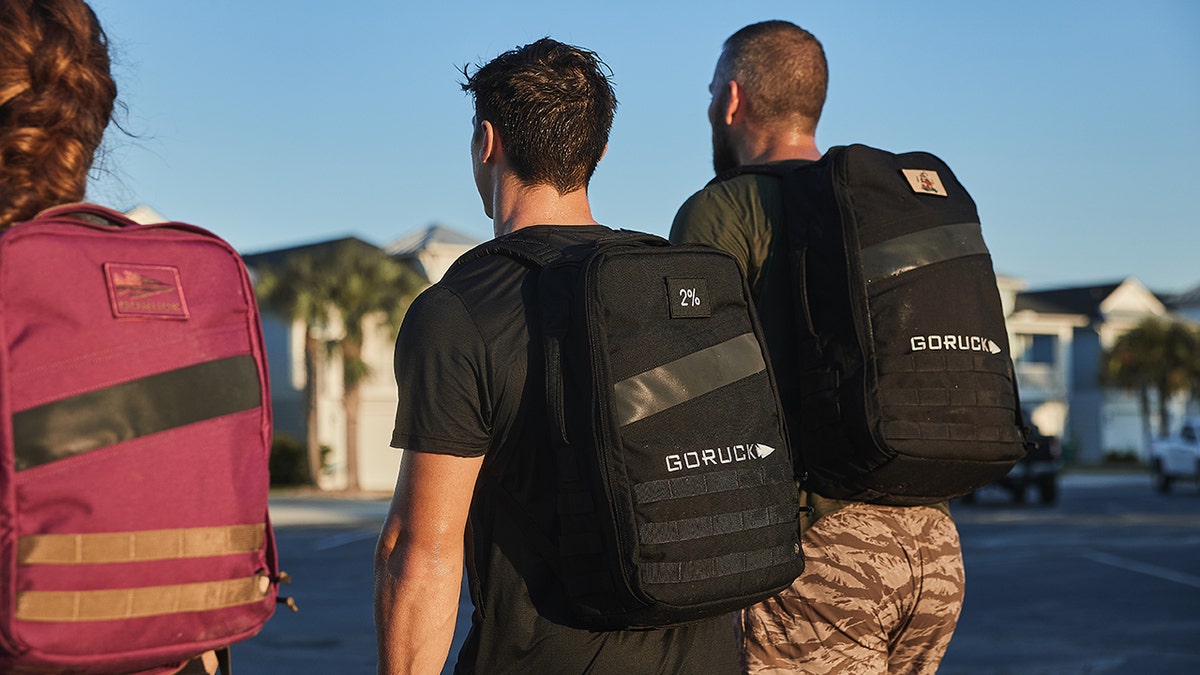 men rucking with backpacks