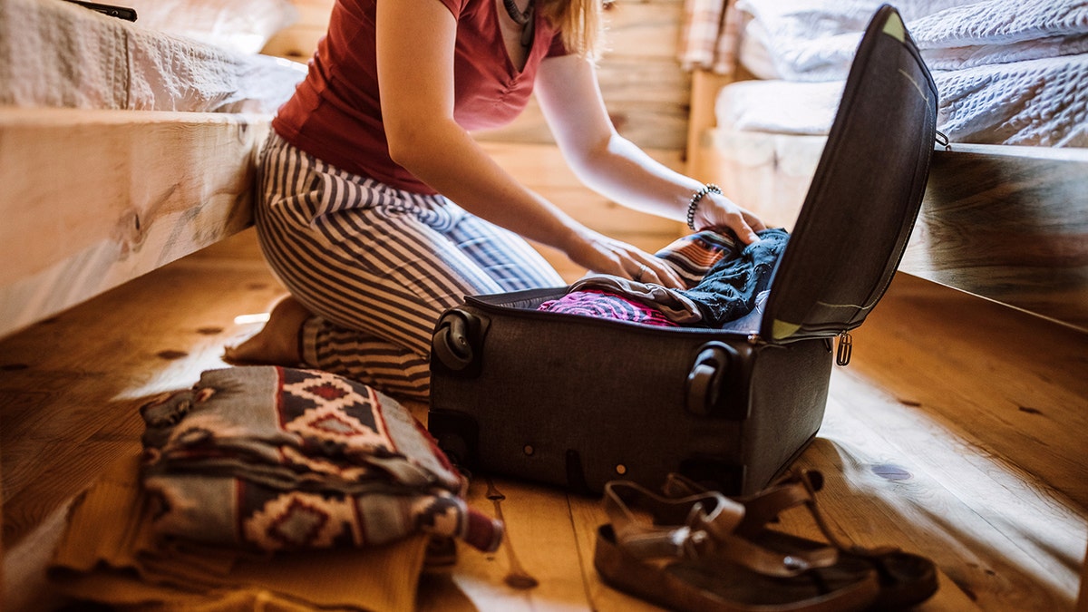 unpacking bag of clothes after traveling