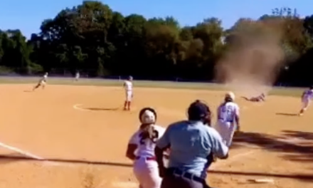 Virginia softball player contends with dust devil as she makes diving play for out