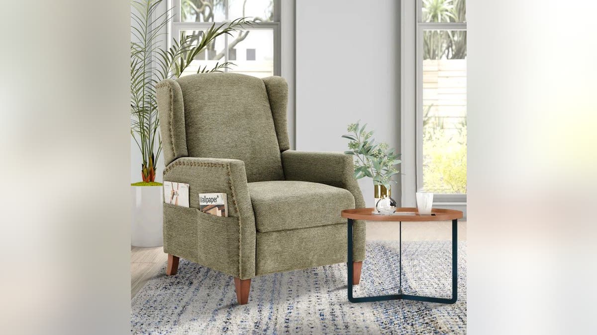 This upholstered recliner features a wing-back design.