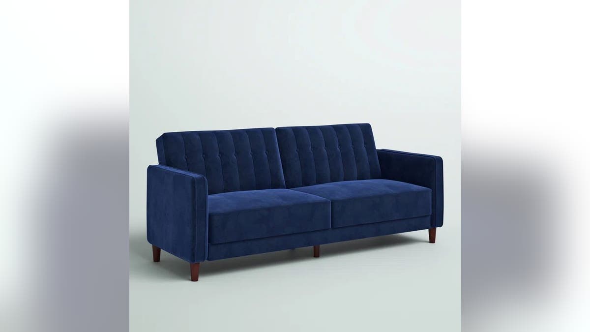 Elevate your living space with this velvet convertible sofa.