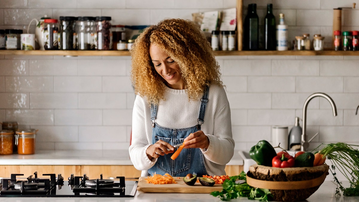 A woman cooking in her kitchen