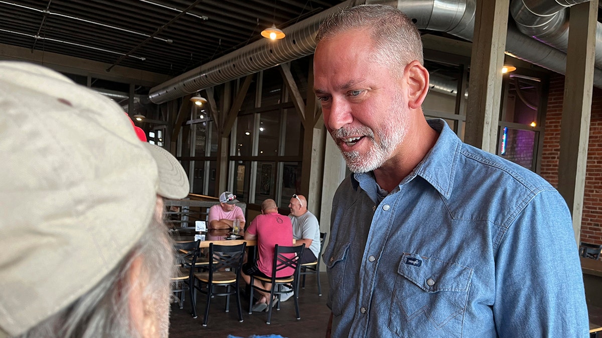 Independent Dan Osborn, a challenger to two-term Republican Sen. Deb Fischer, chats with guests at a brewery in Beatrice, Neb., on July 30.