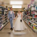 Newlyweds return to the grocery store where they met to take wedding photos