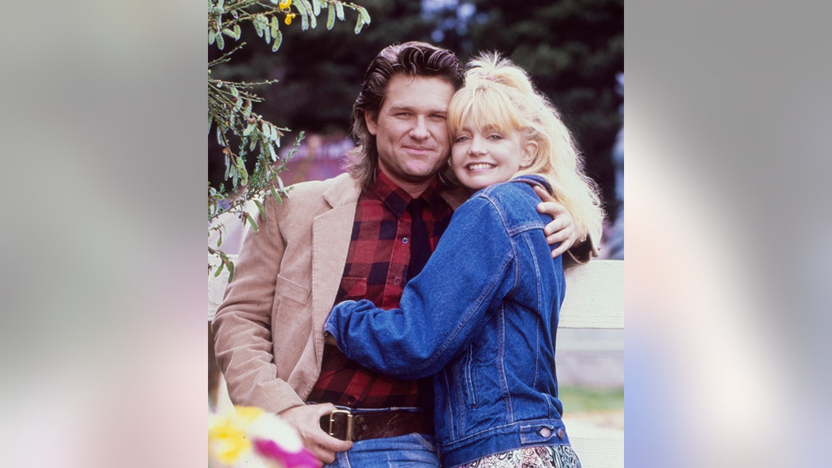 Kurt Russell and Goldie Hawn hugging on the set of 