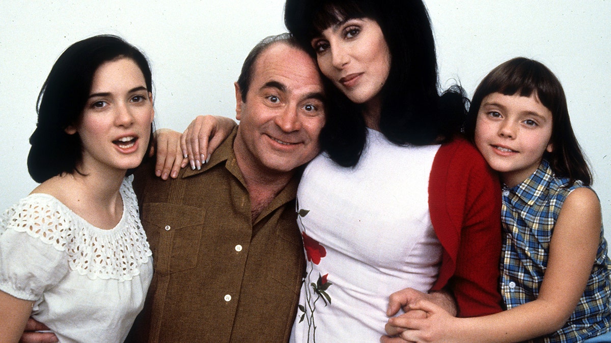 Winona Ryder in a t-shirt, Bob Hoskins in a button-down, Cher in a white top, and Christina Ricci in a plaid top pose for promotional shot for their movie, 