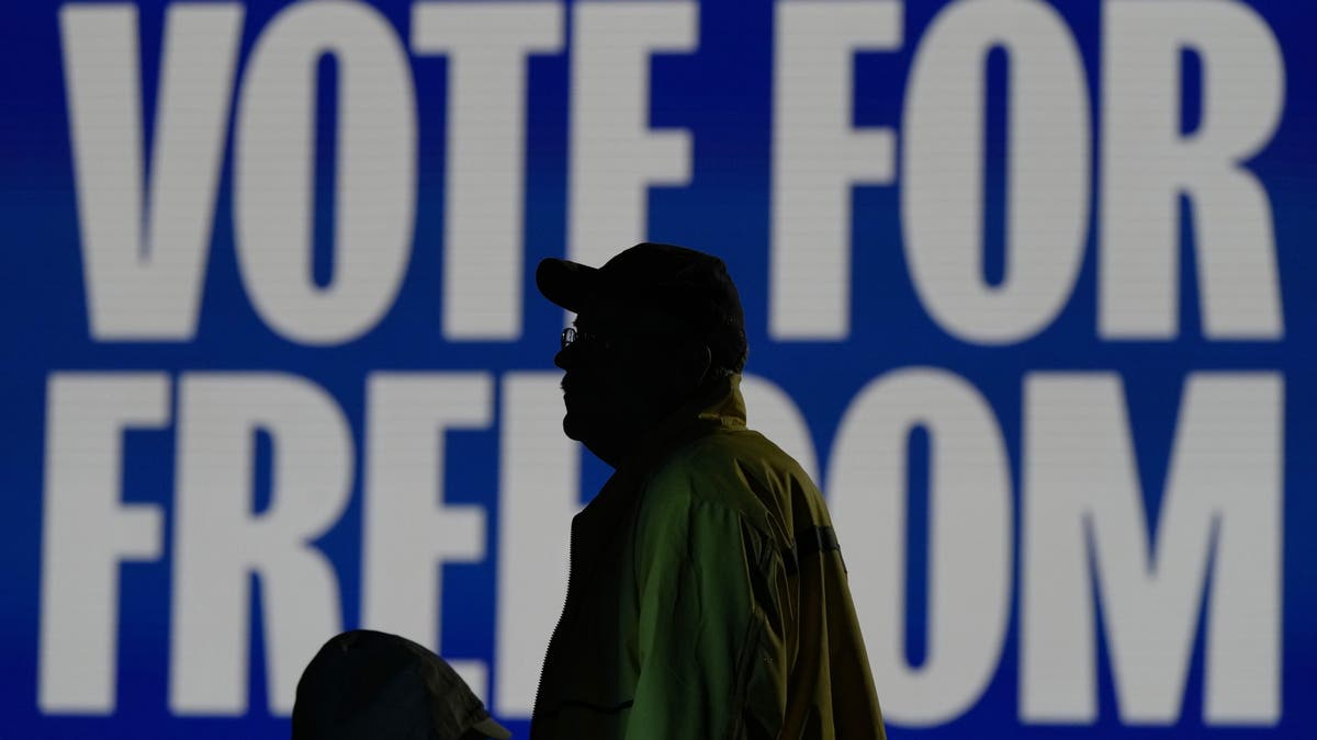 An attendee waits at a campaign rally for Democratic vice presidential nominee Minnesota Gov. Tim Walz, Monday, Nov. 4, 2024, in Detroit.