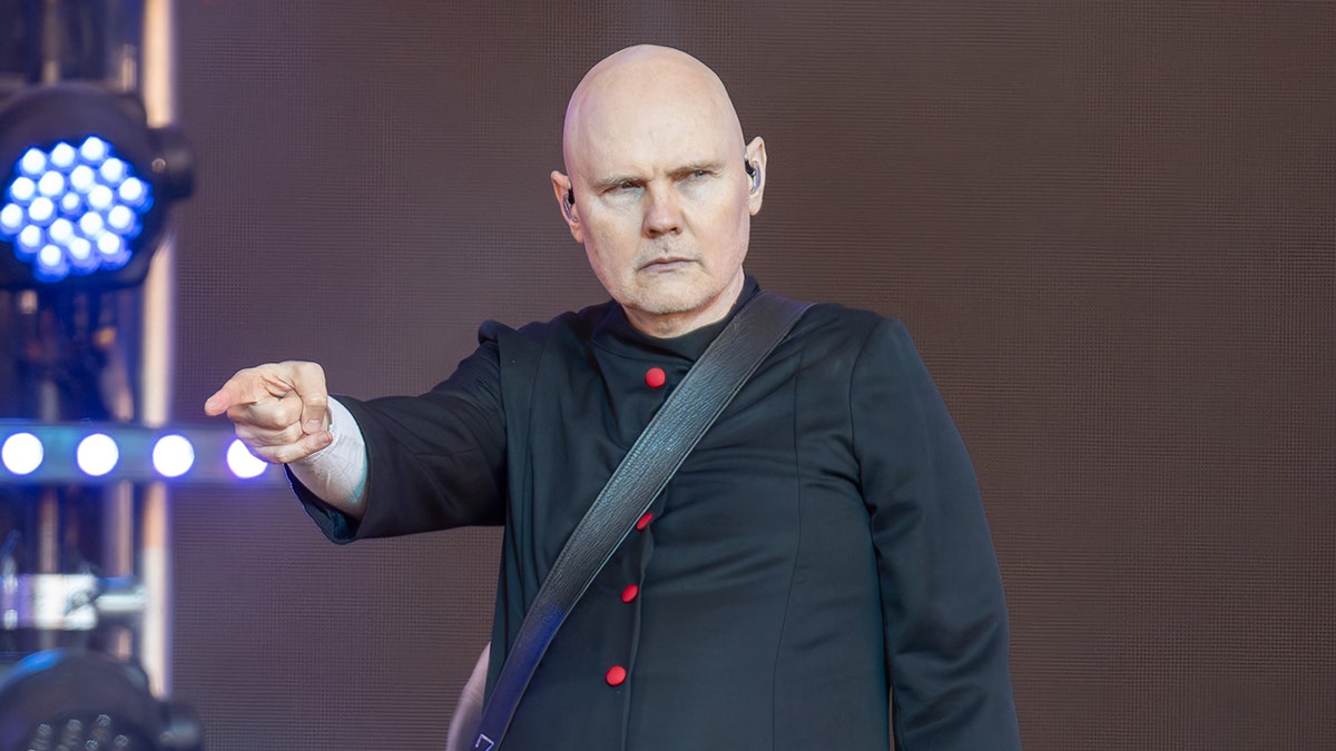 Billy Corgan points onstage