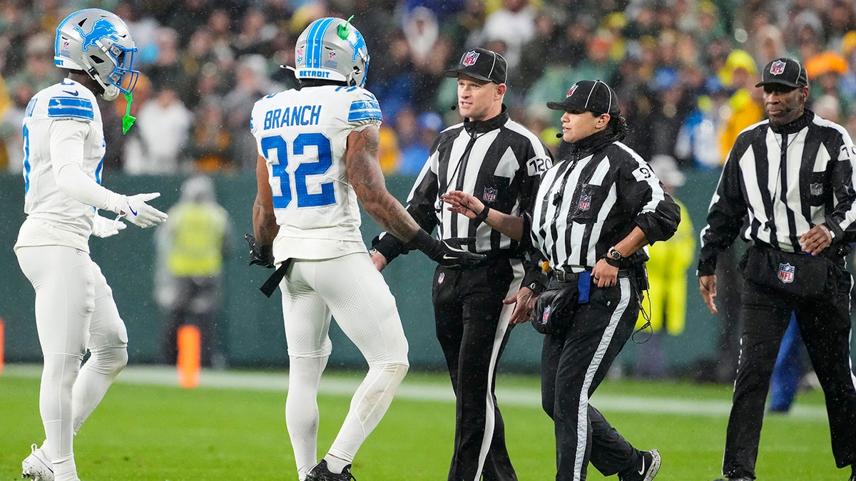 Brian Branch talks to officials