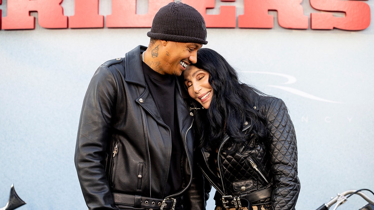 Cher and her boyfriend, Alexander Edwards, cuddled while posing for photos at the premiere of 