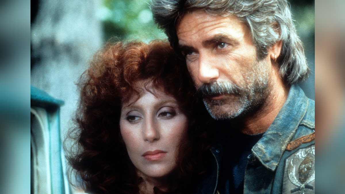 Cher and Sam Elliot look pensive in a scene from the 