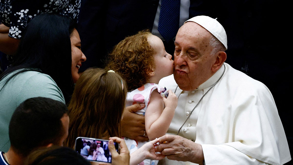 Child kissing the pope