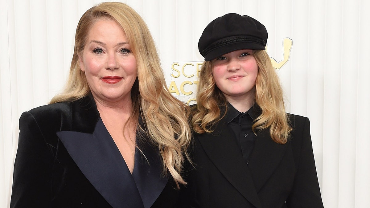 Christina Applegate in a black blazer with daughter Sadie wearing a black suit and hat