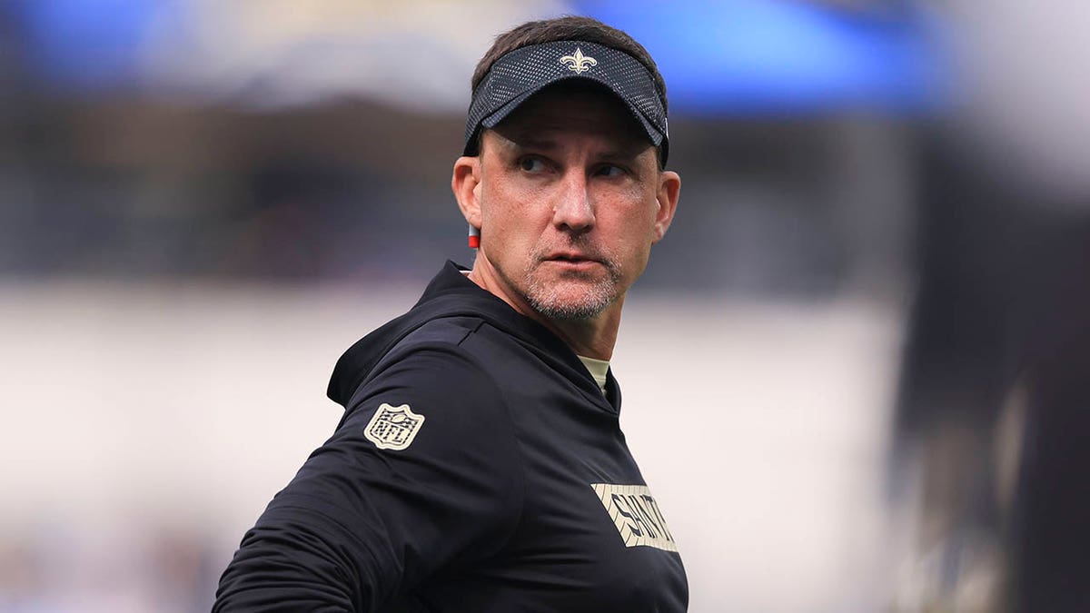 Dennis Allen looks on