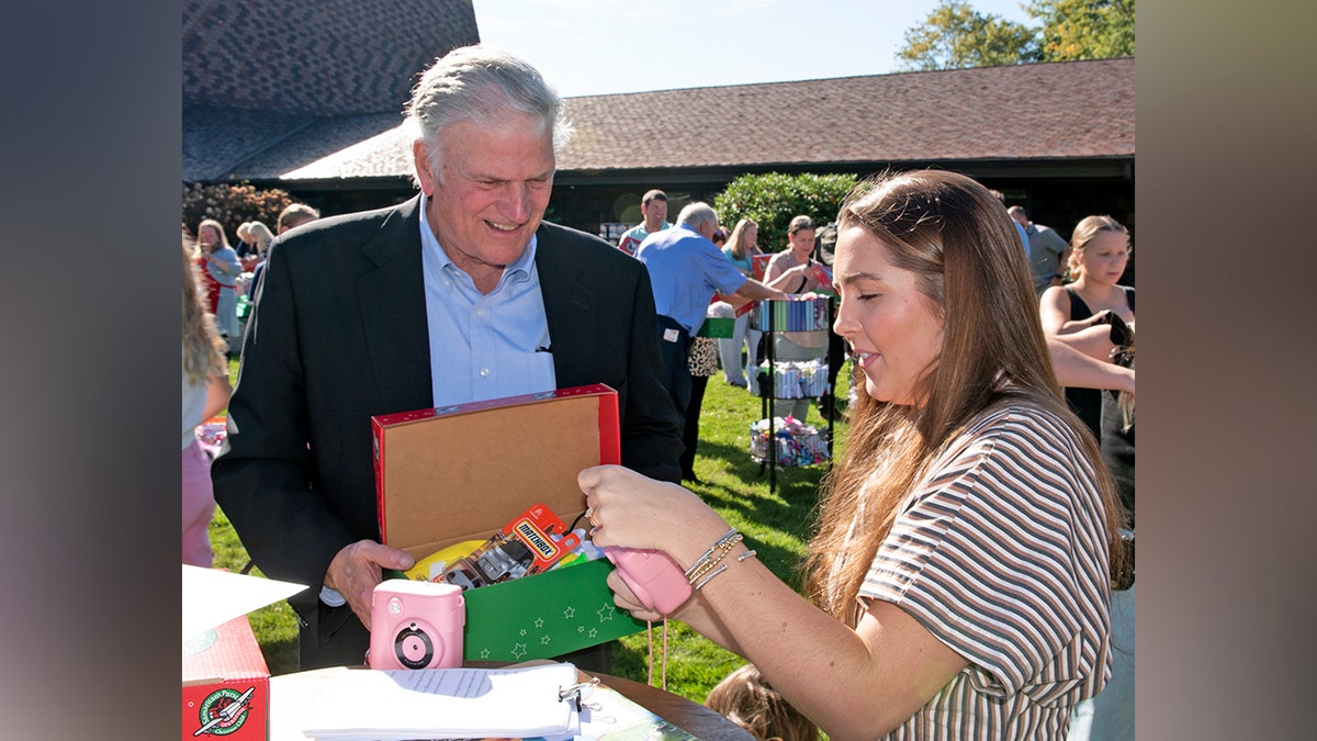 Rev. Franklin Graham loads a donated shoebox for Operation Christmas Child