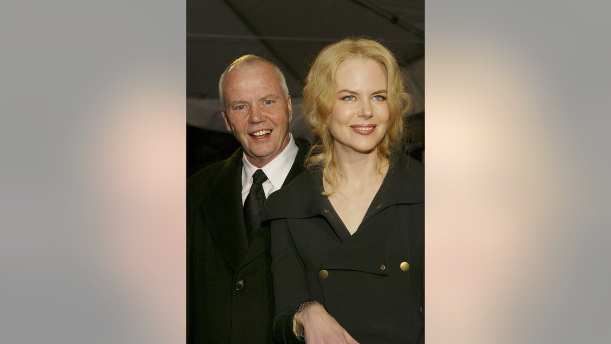 Nicole Kidman and her father Anthony posing in matching black outfits.