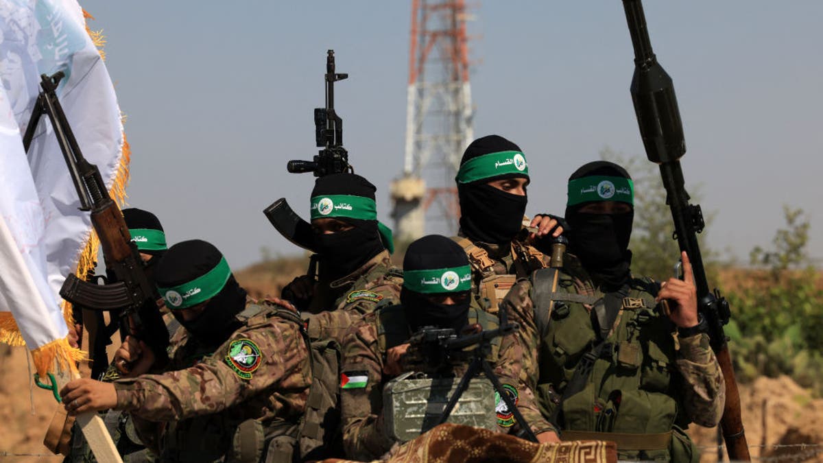 Hamas terrorists of the al-Qassam Brigades take part in a military parade to mark the anniversary of the 2014 war with Israel, in the central Gaza Strip on July 19, 2023.