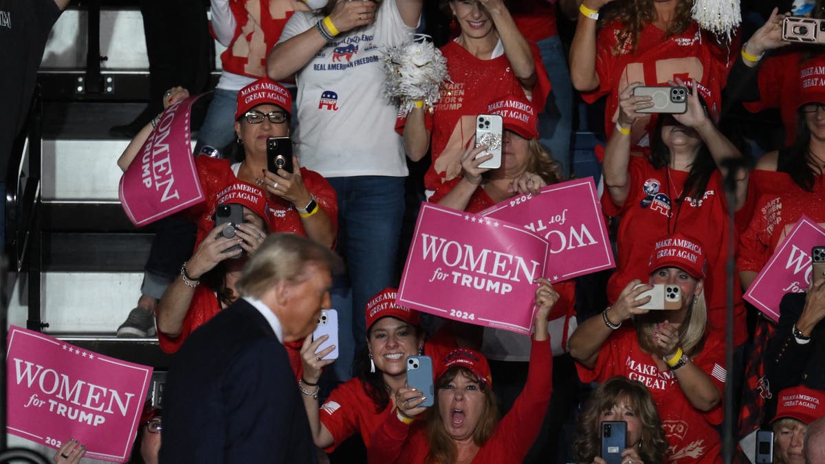 Women cheer as former President Donald Trump arrives to speak at a campaign rally in Reading, Pennsylvania, on Nov. 4, 2024.