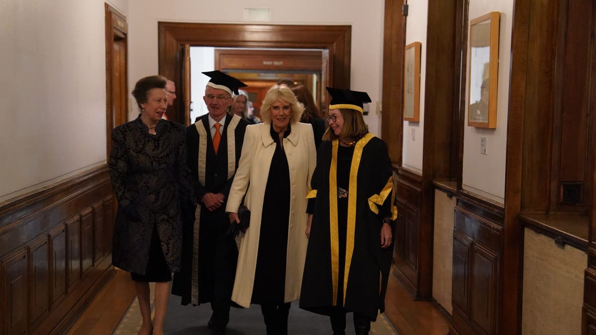 camilla and anne walking down a hall