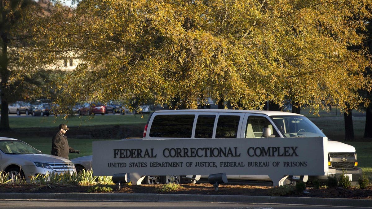 A security guard checks vehicles entering the Butner Federal Correctional Complex