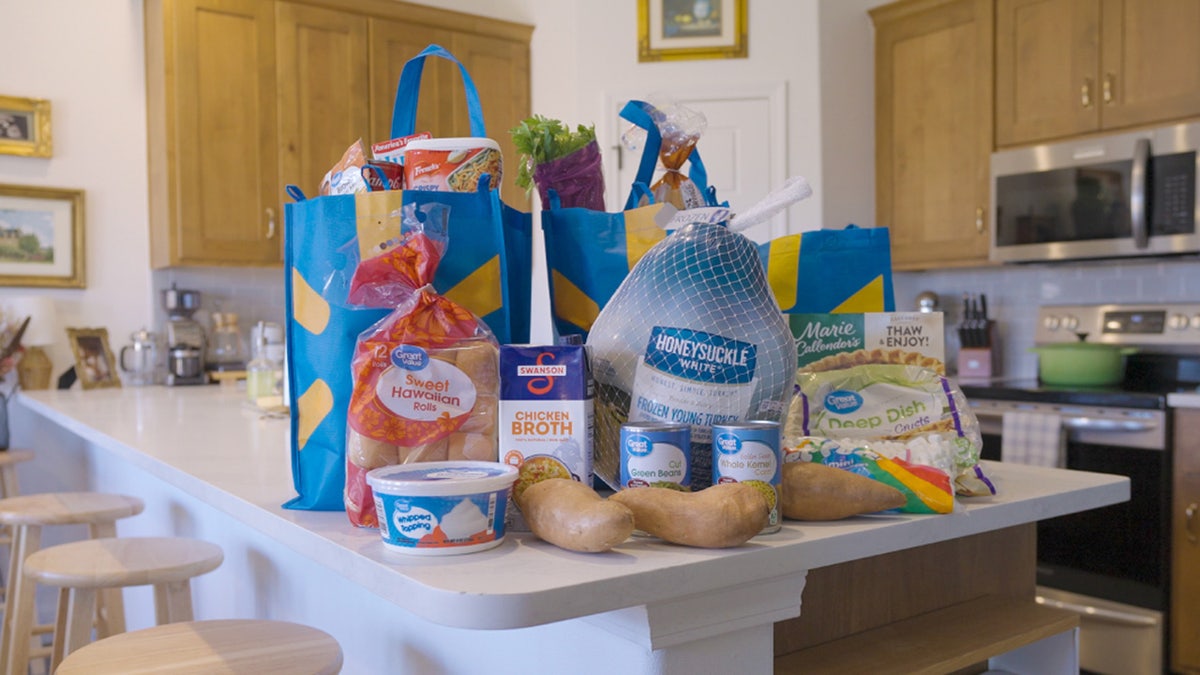 A collection of items used to make a thanksgiving dinner on a kitchen table.