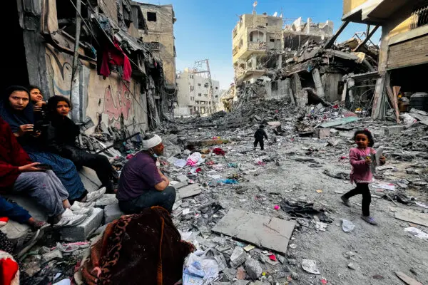 Gazans sit next to the body of a relative as they look at the rubble of their building after an Israeli strike in Beit Lahia, in the northern Gaza Strip, on Oct. 29, 2024. (AFP via Getty Images)