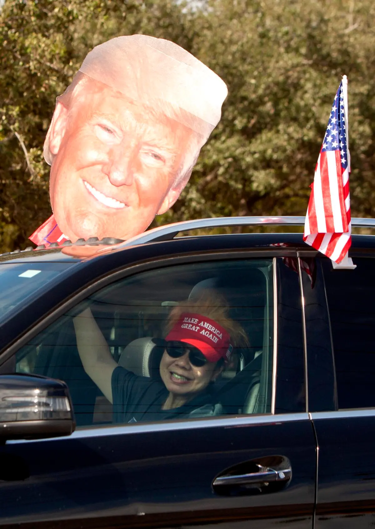 A Trump supporter displays her support for Trump as she participates in a victory rally in McAllen, Texas, on Nov. 9, 2024. (Bobby Sanchez/The Epoch Times)