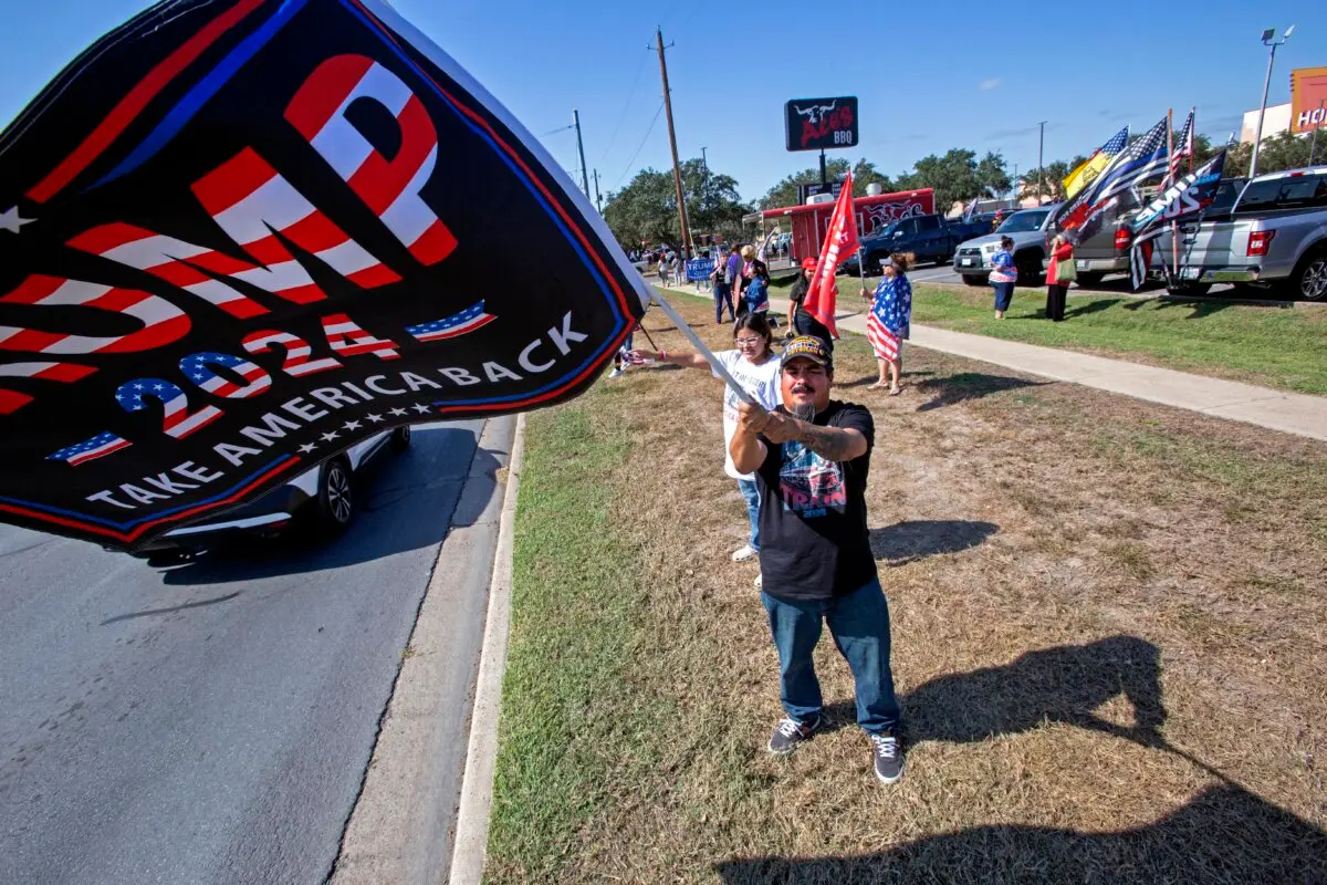 Army veteran Felix Cano, 42, of Weslaco, waves a Trump flag in McAllen, Texas, on Nov. 9, 2024. (Bobby Sanchez/The Epoch Times)