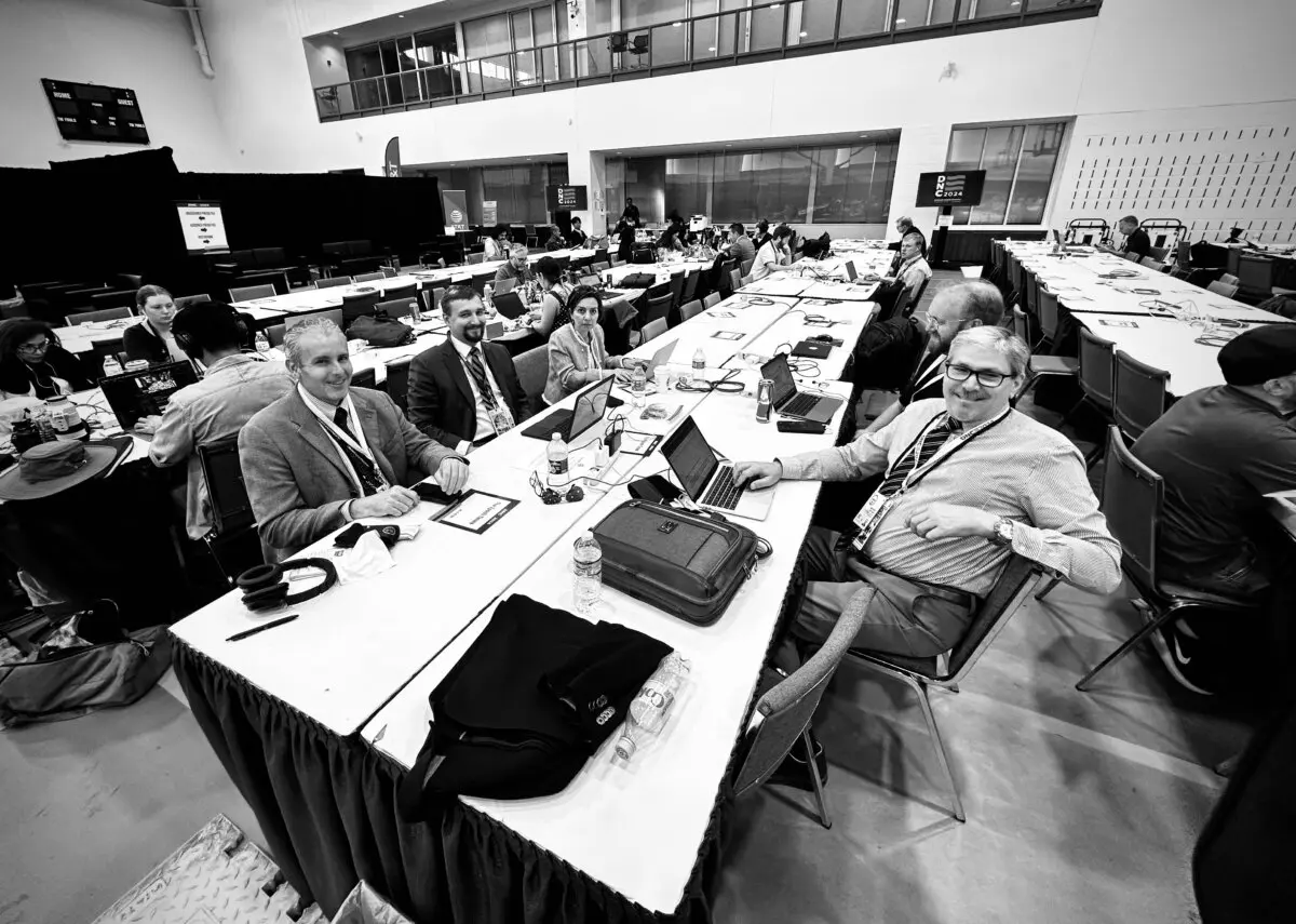 Epoch Times reporter Lawrence Wilson (R) works alongside colleagues and other journalists at the Democratic National Convention in Chicago, Ill., on Aug. 22, 2024. (John Fredricks/The Epoch Times)