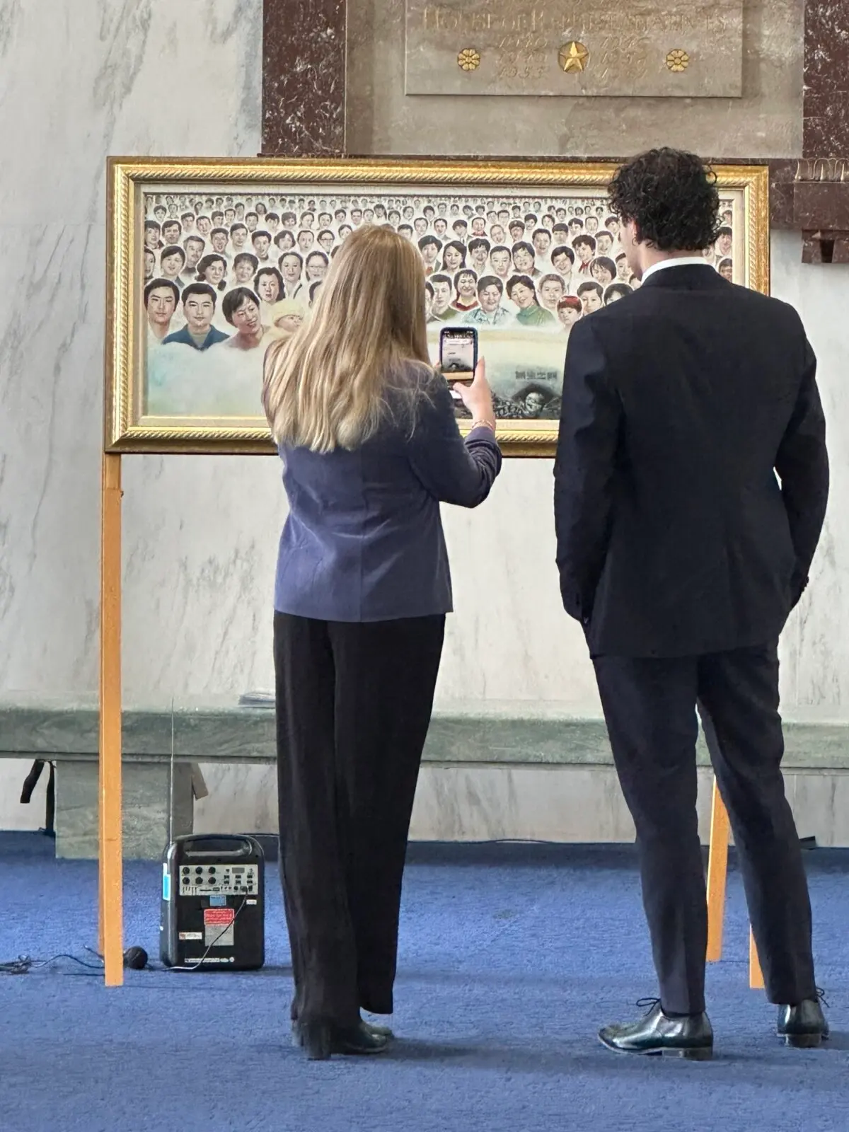 Congressional staffers at the Art of Zhen, Shan, Ren (Truth, Compassion, Tolerance) International Exhibition at the foyer of the Rayburn House Building in Capitol Hill, Washington, on Nov. 13, 2024. (Jenny Jing/The Epoch Times)