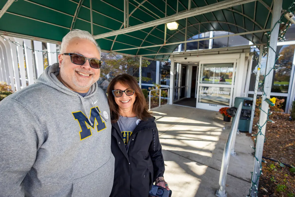 Andy Kollin stands next to his wife after voting in Farmington Hills, Mich., on Oct. 26, 2024. (John Fredricks/The Epoch Times)