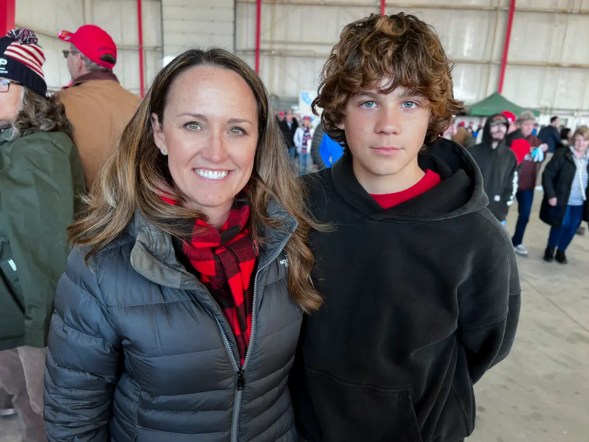 Kristin Short of Bay City, Mich., and her son, Owen Short, attend a rally for former President Donald Trump in Traverse City, Mich., on Oct. 25, 2024. (Lawrence Wilson/The Epoch Times)