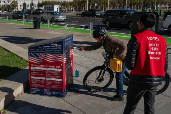 A voter drops off ballots at an official ballot drop box on the final day of early voting ahead of Election Day at City Hall in San Francisco, on Nov. 4, 2024. (Loren Elliott/Getty Images)