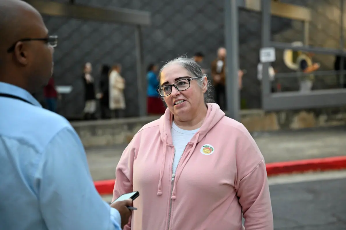 Elizabeth Gonzalez, the first voter in line to vote at this location, speaks with a reporter at the Buckhead voting precinct in Atlanta on Nov. 5, 2024. (Jim Blackburn for The Epoch Times)