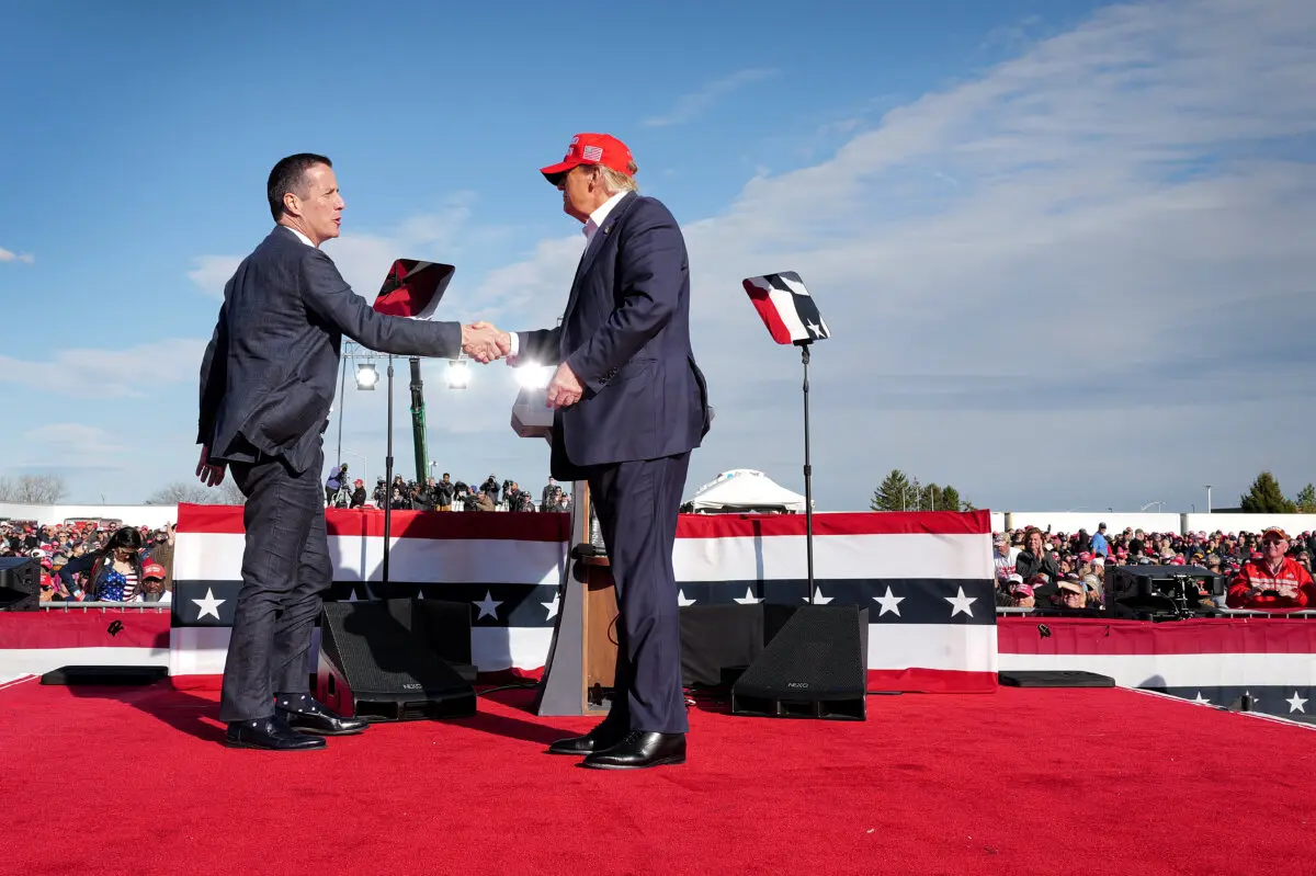 Republican presidential candidate former President Donald Trump (R) greets Ohio Republican candidate for U.S. Senate Bernie Moreno (L) during a rally at the Dayton International Airport in Vandalia, Ohio, on March 16, 2024. (Scott Olson/Getty Images)