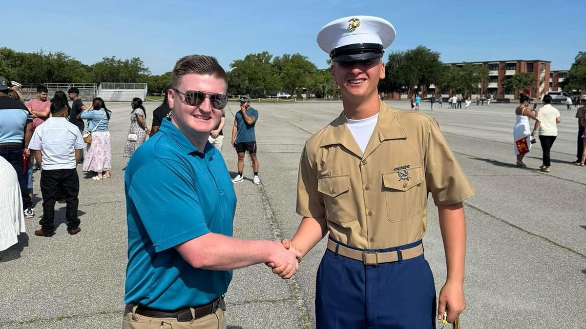 Deputy John Sanders shakes Pvt. Brian Gilbert's hand at his graduation from bootcamp in Parris Island, SC