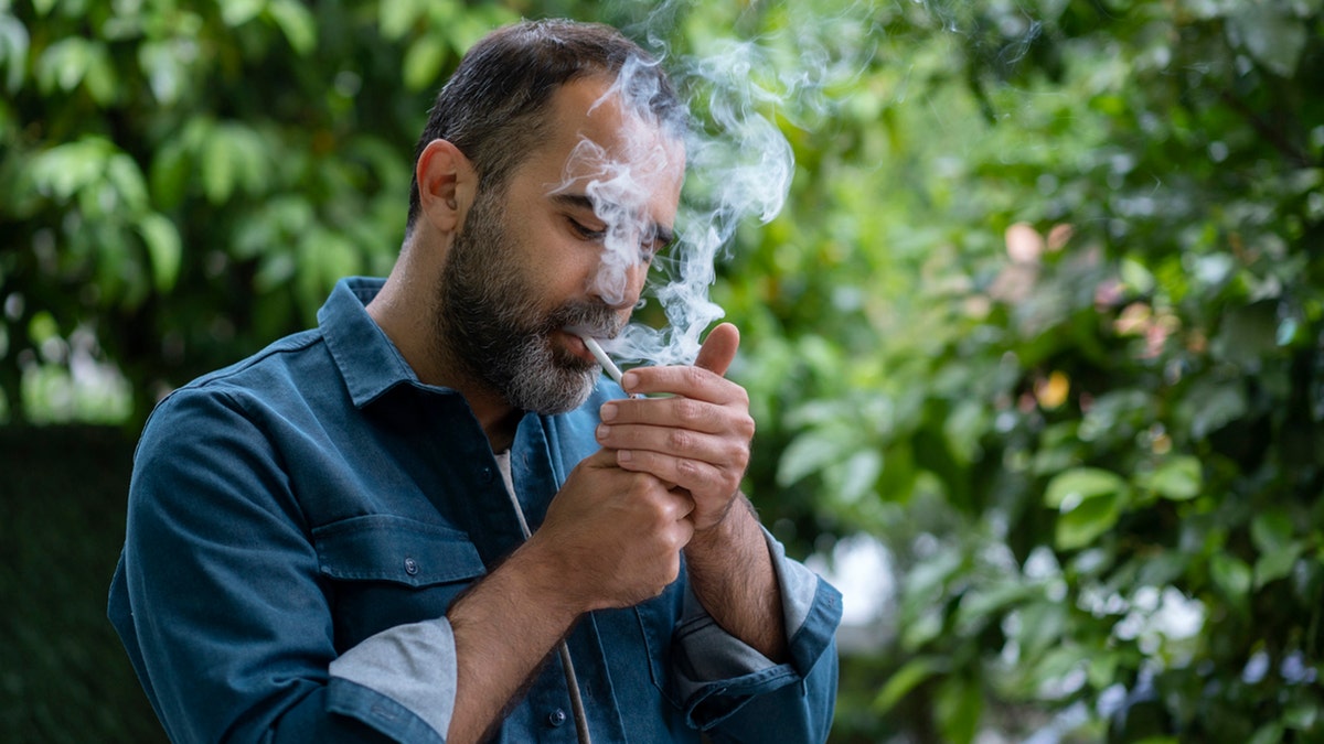 man smoking a cigarette