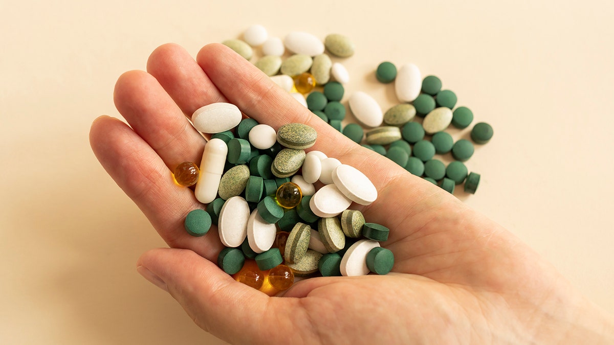 hand holding miscellaneous pills