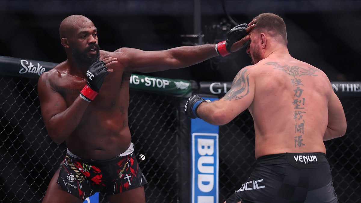 Jon Jones strikes Stipe Miocic