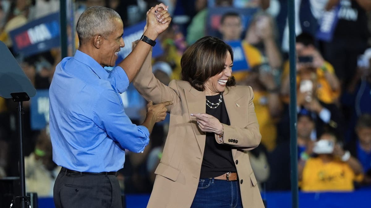 Former President Barack Obama gestures to Democratic presidential nominee Vice President Kamala Harris after introducing her to speak during a campaign rally for Harris on Thursday, Oct. 24, 2024, in Clarkston, Ga.