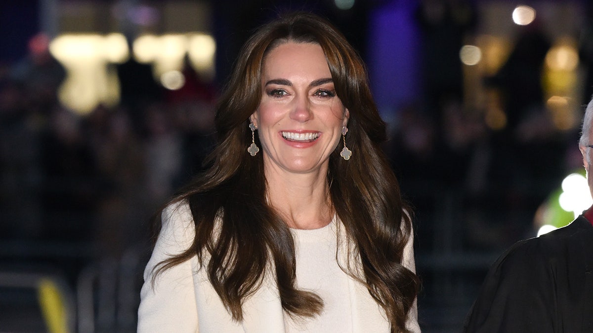 Kate Middleton wearing white and smiling