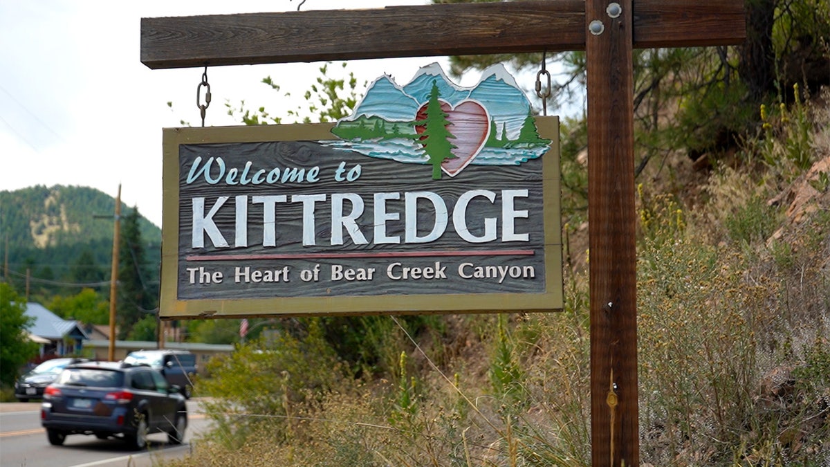 Kittredge welcome sign hanging by road