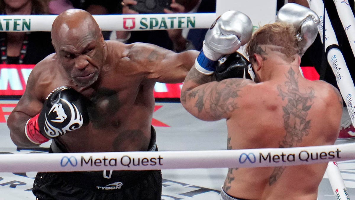 Mike Tyson lands a left