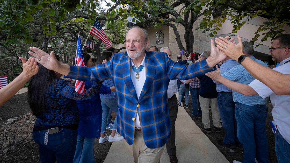 USAA veteran with flags behind him