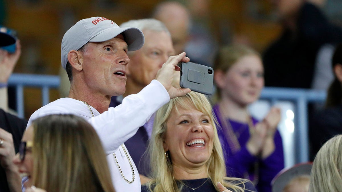 Brent Venables and his wife watch a game