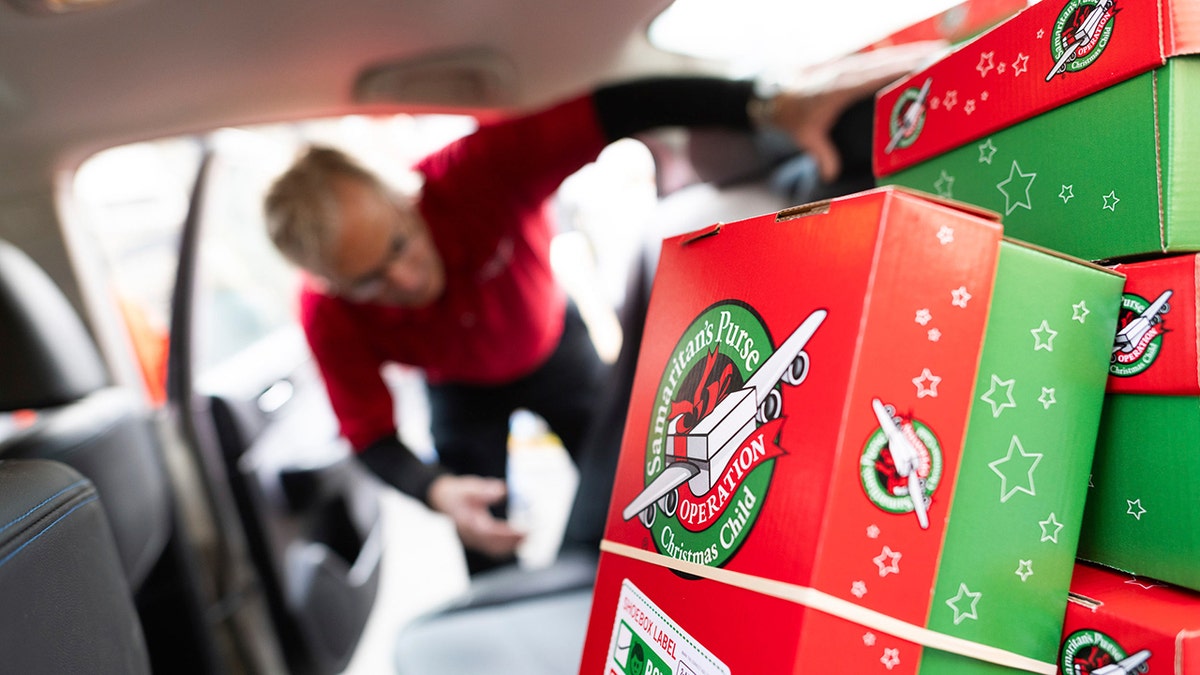 A volunteer loads Operation Christmas Child shoeboxes